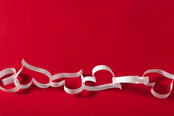 istock Decorative white paper hearts on vibrant red background for romantic occasions 2250713113