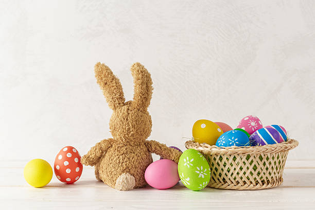 istock Colorful Easter eggs and a cute bunny toy on a light background for holiday decorations 2250714418