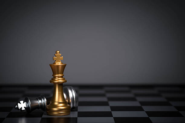 istock A golden chess king standing victorious beside a fallen silver king on a dark board, symbolizing strategy, leadership, competition, success, decision-making, and power in a high-stakes environment. 2250716299