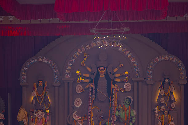 A beautifully crafted handmade colorful goddess durga idol decorated for Navratri, featuring vibrant traditional attire, intricate jewellery, and divine expressions at colorful pandal.