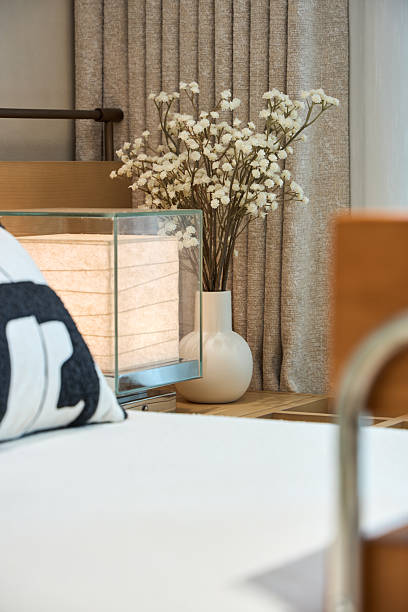 Electric lights and flowers on the bedside table