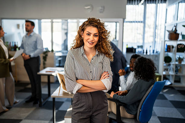 istock Confident businesswoman smiling in modern office environment 2250726431