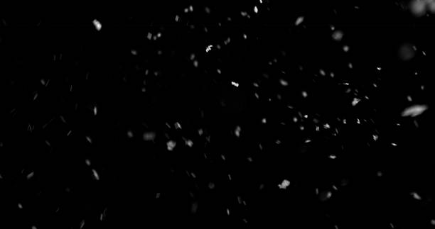 istock Falling snowflakes isolated on black background 2250726500