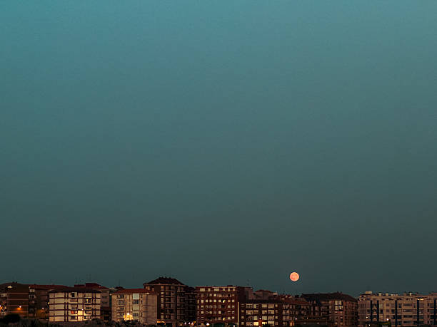 istock The full moon rises over the city 2250726762