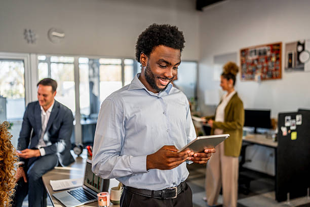 istock Smiling businessman using digital tablet in modern office 2250727720
