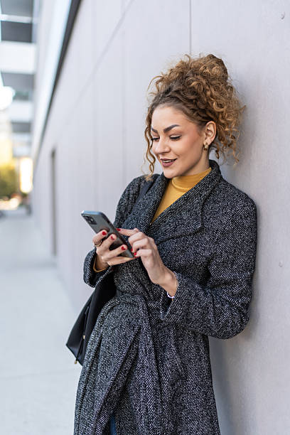 istock Young woman enjoying communicating using smartphone 2250728061