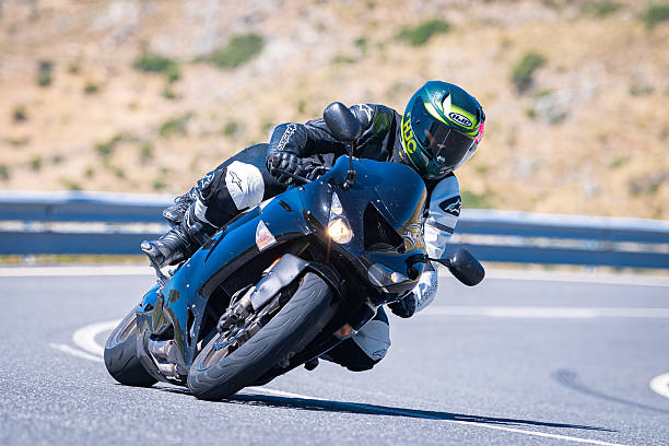 Biker riding fast on a winding mountain road in Ávila, Spain, in August., 2023