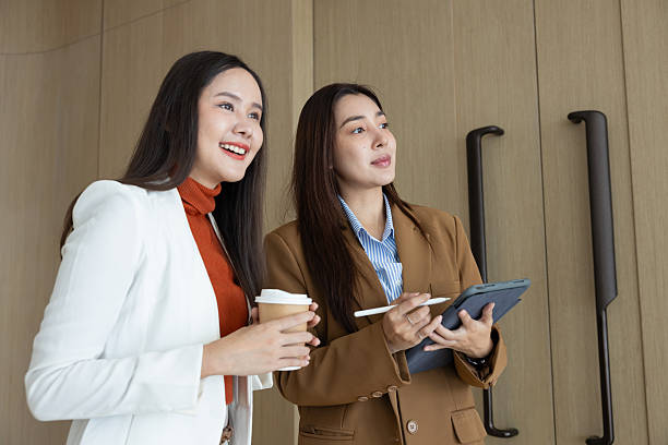 istock Smiling businesswomen chatting during coffee break 2250728719