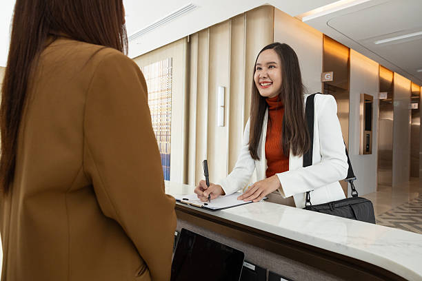 istock Businesswoman checking in at office reception desk 2250728780
