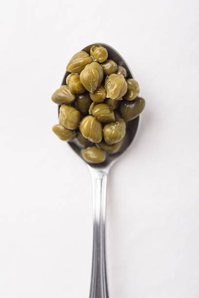 Pickled capers on white background. Healthy food ingredient