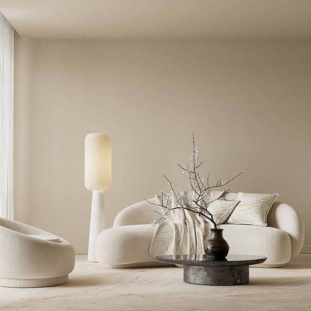 istock Japandi soft minimalist negative space scene featuring warm lamp glow, sculptural tables and curved cream seating for a tranquil modern interior. 3D illustration. 2250734842