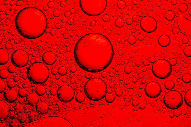 istock Red bubble surface macro,Close-up of water drop surface on red drink glass,Red close-up macro drink water drop surface,Water droplets on a glass of red cold drink for background and texture 2250737244