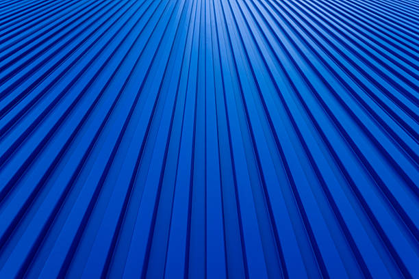 Blue zinc backdrop,Wide surface of the Blue aluminum wall for background design,Blue technology background,Modern blue building wall backdrop,Background with texture of metal cladding.Blue stripes of modern architecture,