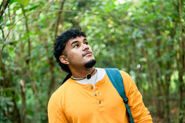 istock Young man hiking in forest looking up exploring nature 2250738011