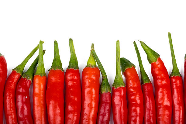 istock Fresh red chili peppers arranged on a white background for cooking and decorating dishes 2250740239