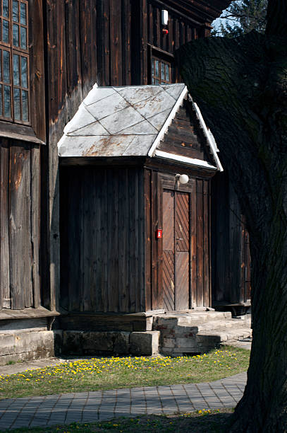 Wooden church. Architectural details. Probołowice, Poland. The wooden parish church of St. James the Apostle from 1759 and the wooden bell tower from the mid-19th century