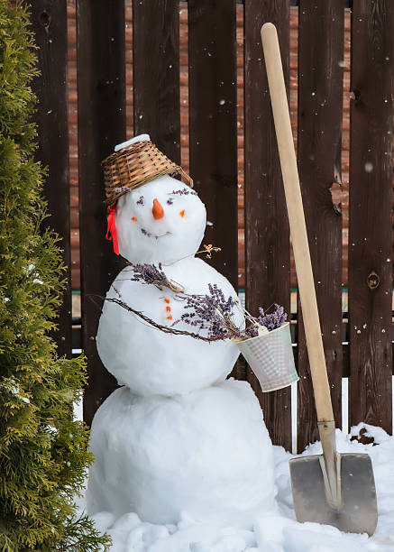 istock Snowman with a shovel 2250741026