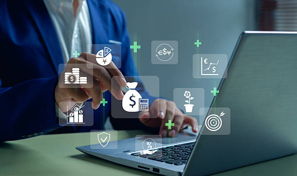 istock Business professional using a laptop with floating digital finance icons, representing investment planning, fintech innovation, online banking, and modern money management in a tech-driven economy. 2250741764