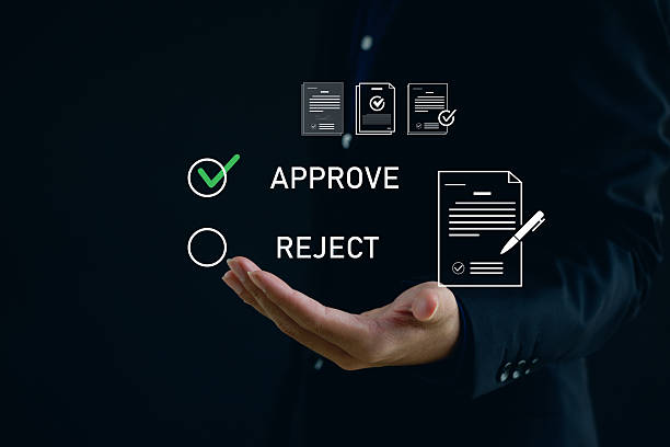 istock business professional presenting digital approval interface with options to approve or reject documents, representing decision-making, workflow management, corporate authorization. 2250741770