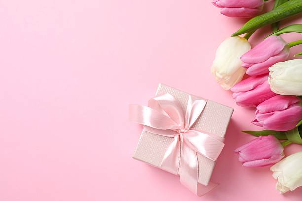 istock Beautiful fresh tulips with gift box on color background 2250741942