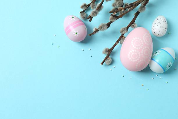 istock Colorful eggs, pussy willow branches, sweet sprinkles on a pastel blue background, space for text or advertising 2250742223