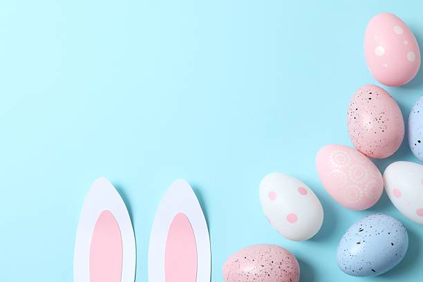 istock Happy Easter. Colorful eggs with bunny ears on color background, space for text or advertising 2250742270