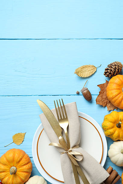 istock Rustic holiday table setup. Top view with plates, cutlery and autumn decorations. Empty space for your text 2250742709