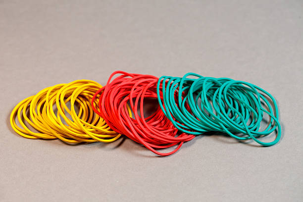 Colored rubber bands for money on a colored background. Stationery accessories