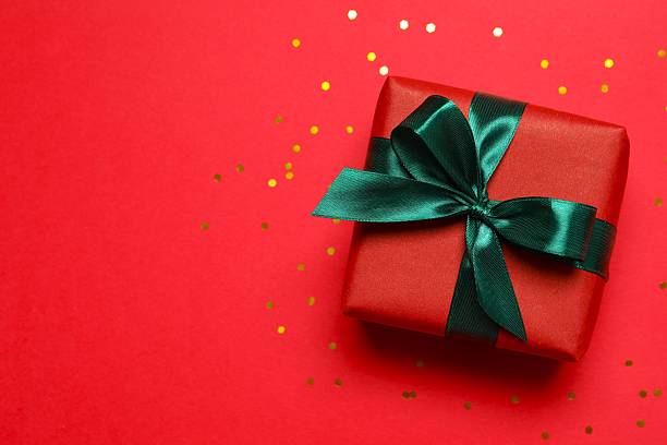 istock Beautiful gift box with confetti on color background, top view 2250742812