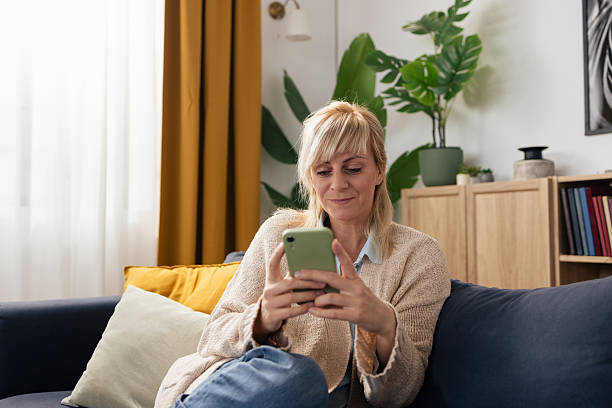 istock Woman relaxing at home using smartphone technology 2250743066