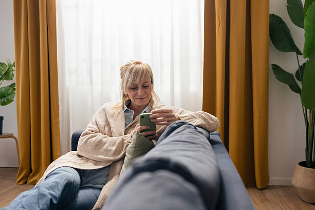 istock Woman relaxing at home using a smartphone 2250743106