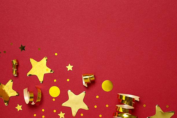 Golden confetti on color background, top view