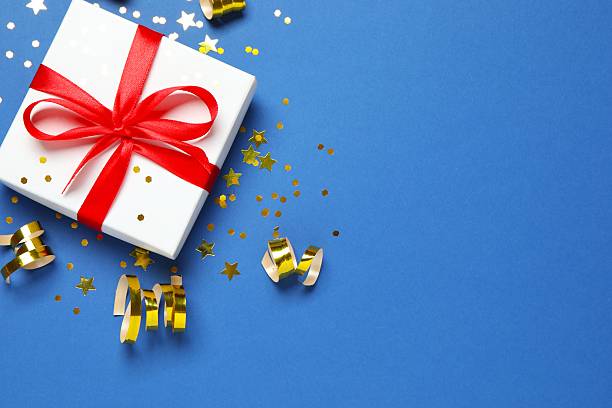 istock Beautiful gift box with confetti on color background, top view 2250745021