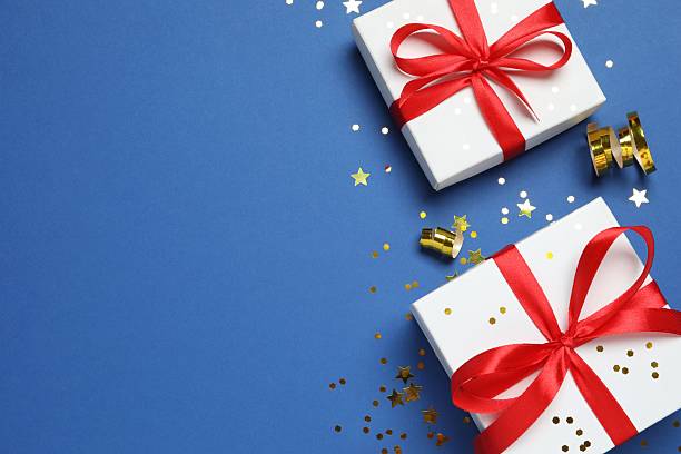 istock Beautiful gift boxes with confetti on color background, top view 2250745022