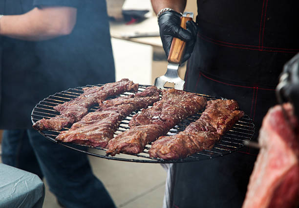 Cooked and juicy meat ready being carried by a person to be served