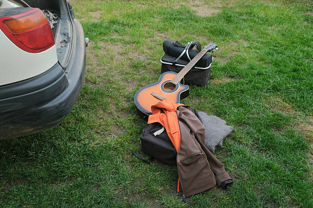 guitar outdoor near car trunk ready for picnic or camping