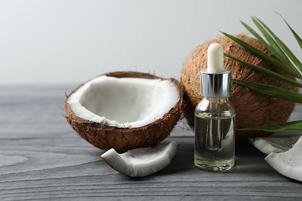 istock Serum bottle of coconut oil on table 2250746079