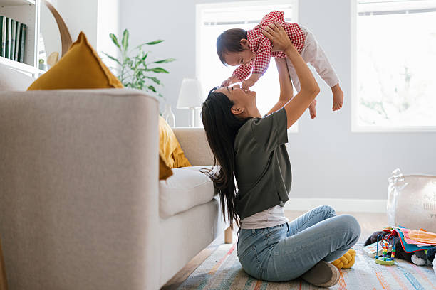 istock Mother Lifting Toddler Above Her Head and Laughing 2250746761
