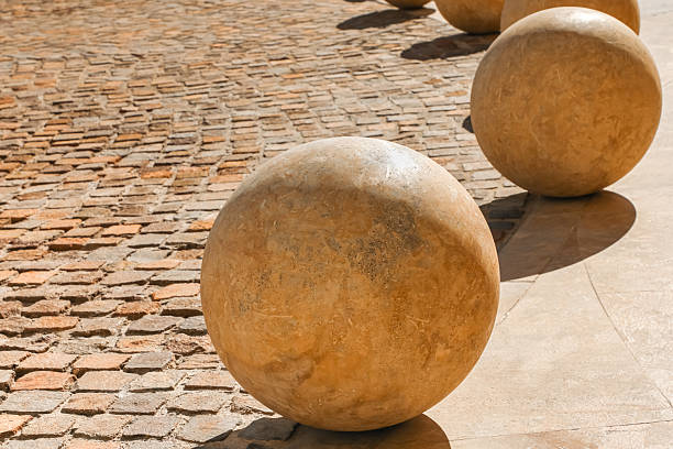 Massive ornamental stone spheres set on a textured paved roadway, creating a stylish, visually rich backdrop suitable for urban design, cityscape concepts, and premium stock imagery.