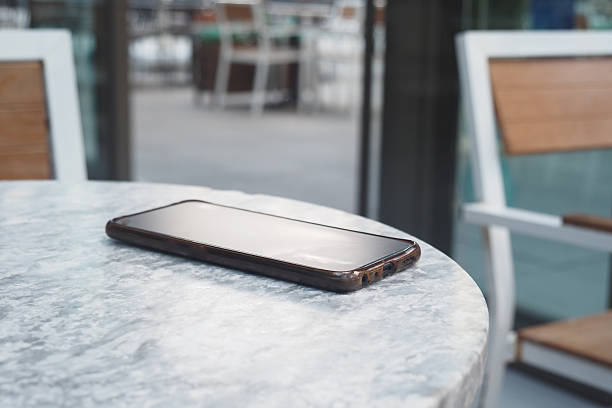 istock Smartphone resting on a table in a cafe setting. lost smart phone concept 2250753826