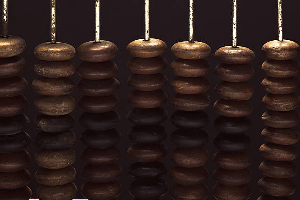 istock Intricate wooden beads arranged in a row with a dark reflective background 2250754379