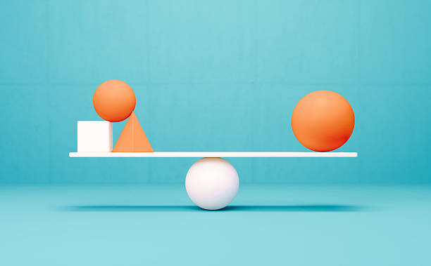 istock Orange And White Colored Geometric Objects Over A White Seesaw Before Blue Background - Balance And Harmony Concept 2250755319