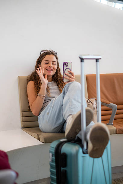 istock Teenager making video call while waiting at airport 2250755340