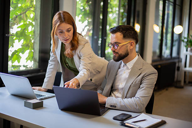 istock Business coworkers collaborating on laptop in modern office 2250756893