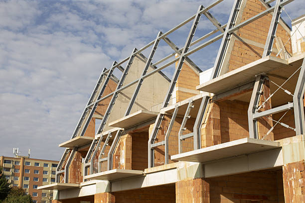 istock Unfinished townhome surrounded by construction materials and light 2250757095