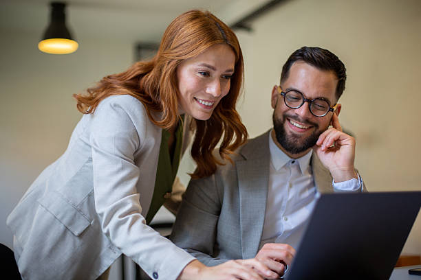 istock Colleagues collaborating on laptop, working together sharing ideas 2250757232
