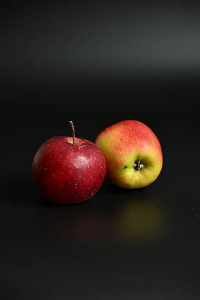 istock Minimalist Still Life: Two Ripe Apples on a Clean Dark Background 2250757387