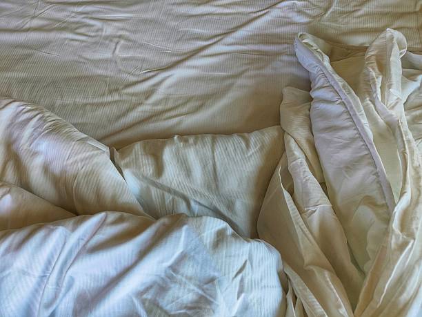istock unmade white bed in the morning 2250758175