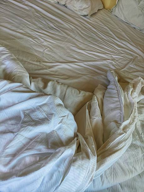 istock unmade white bed in the morning 2250758176