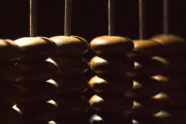 istock Wooden beads lined up on a traditional counting tool in dim lighting 2250758220